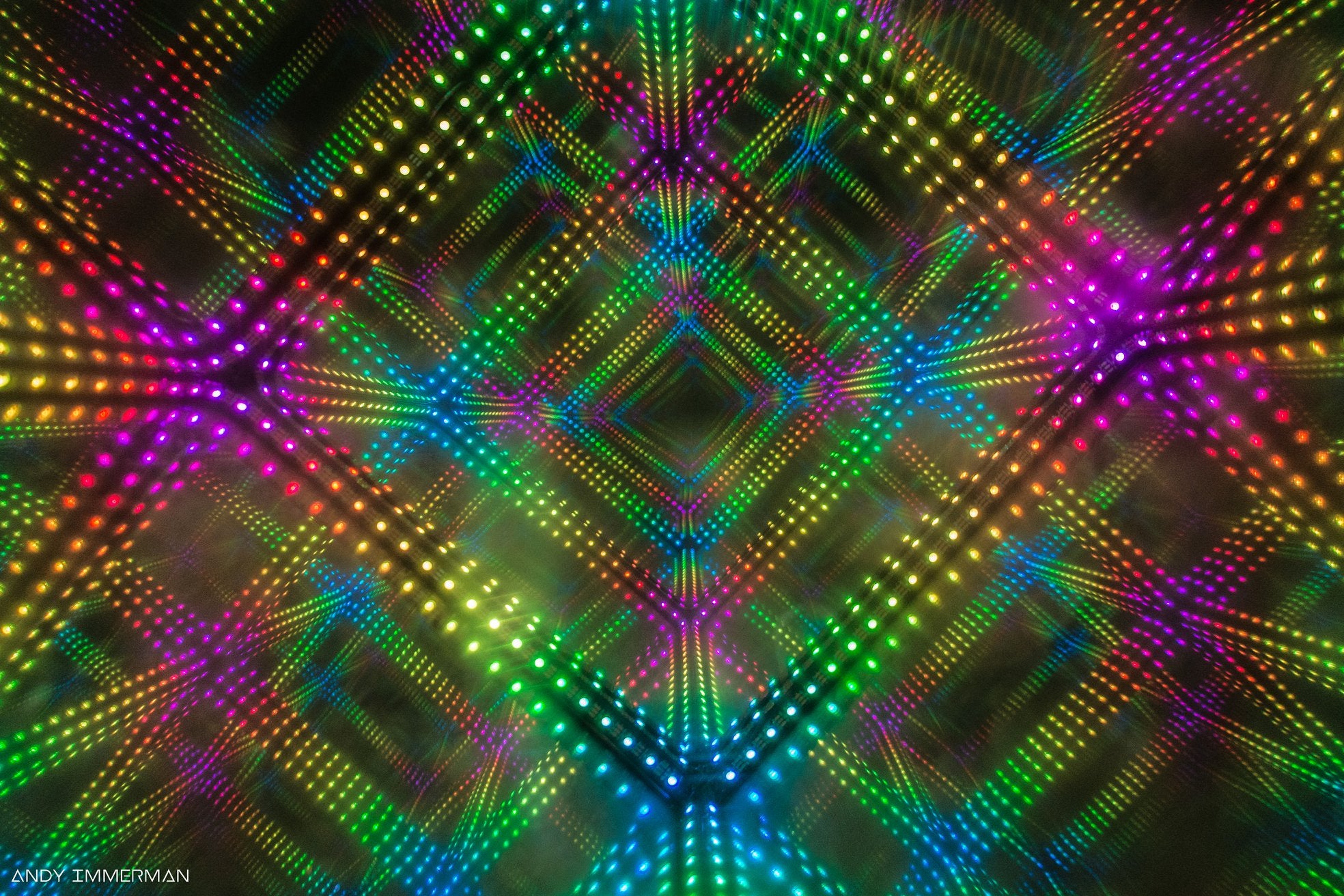 Kaleidoscope-like image of a clear cube with sound sensitive lighting around the edges