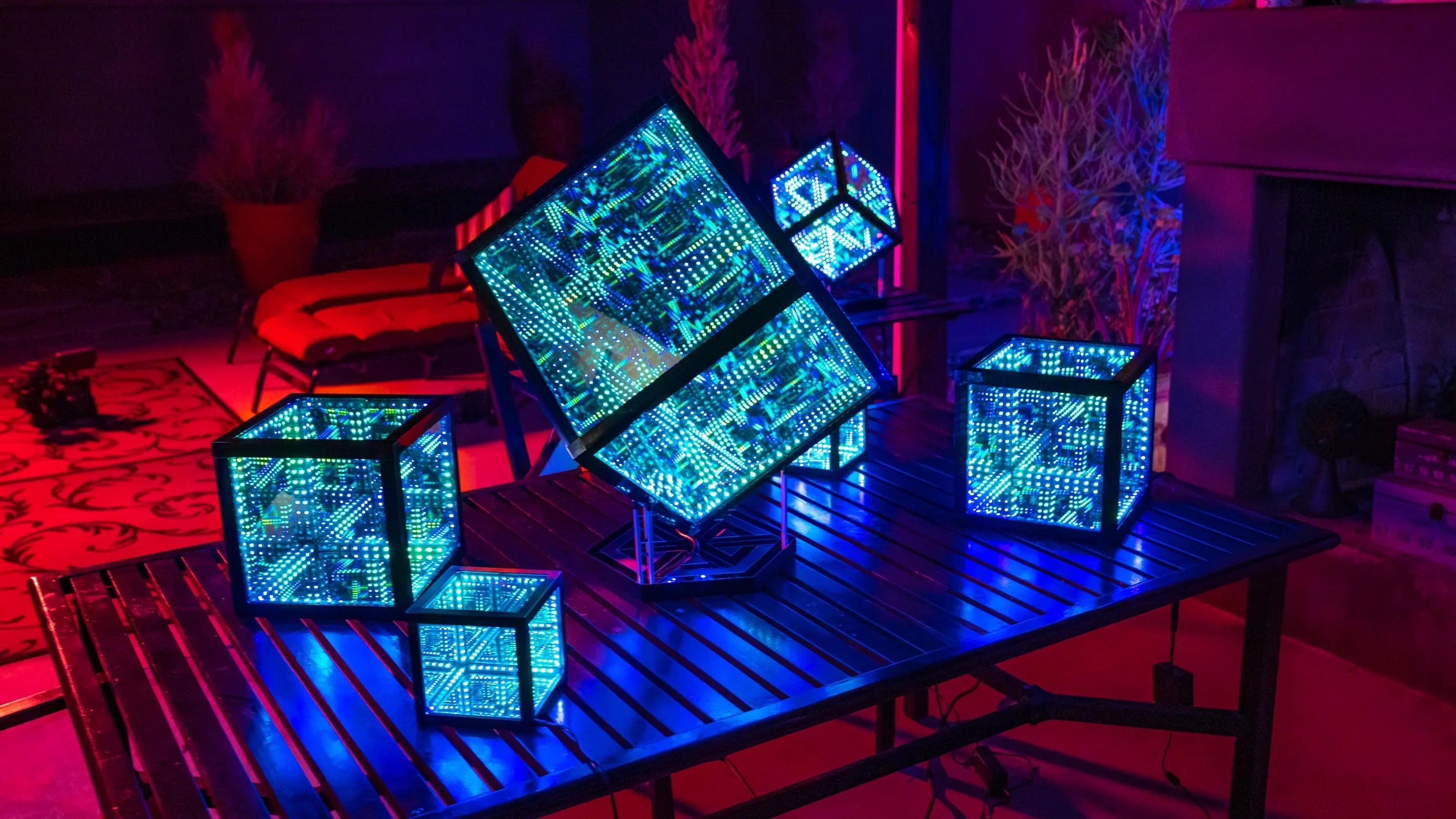 Five cubes with ambient room lighting placed on patrio table outside for decor