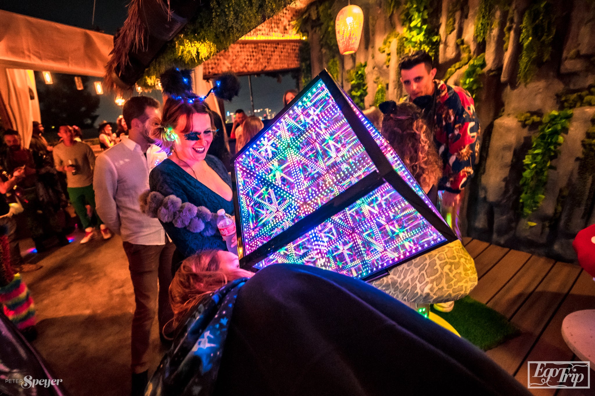 Woman at a festival looking at the Hypercube with sound sensitive lights